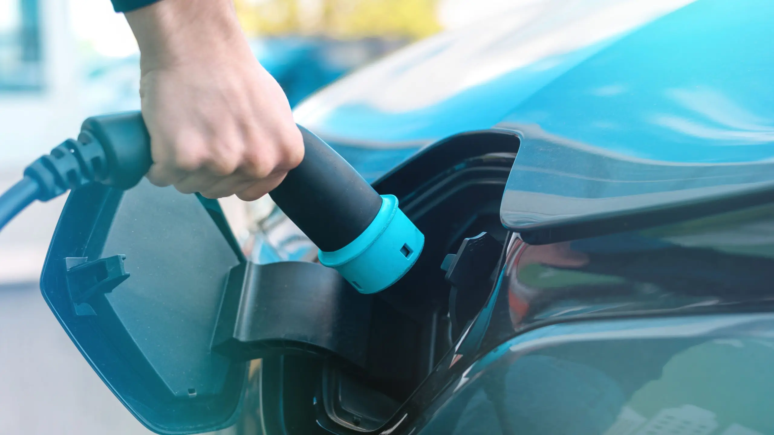 Pessoa a carregar o carro eletrico