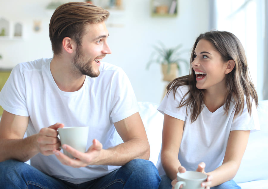 cheerful young couple morning home living room laughing (1)